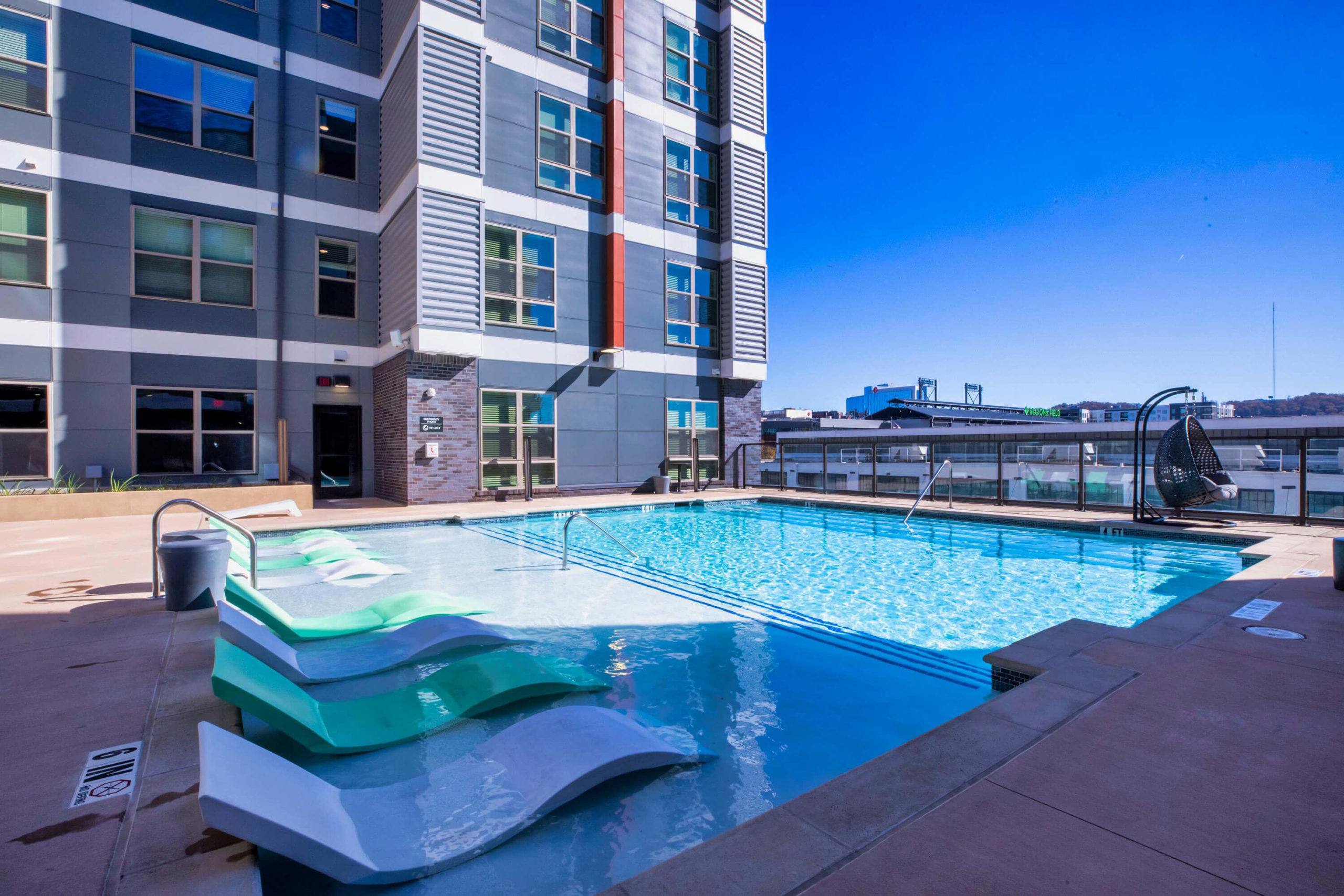 Exterior view of apartments and pool Lumen student apartments near the University of Alabama Birmingham exterior, pool, and apartments